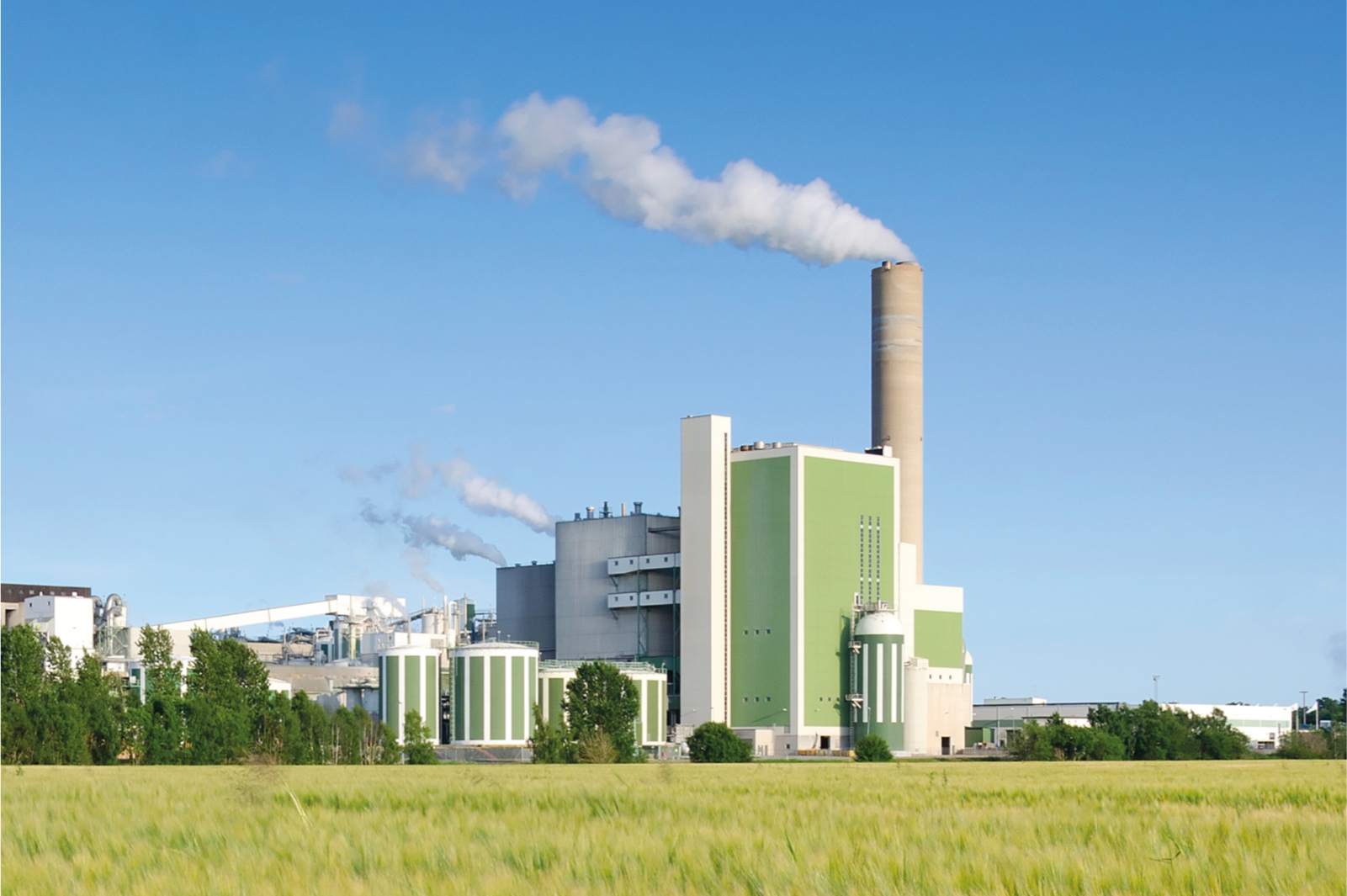 Modern factory with smoke plumes – symbol of industrial energy demand